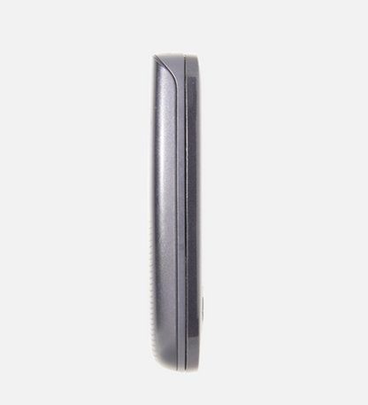 A close-up side profile of a dark gray or black electronic device, possibly a speaker or receiver, on a solid light gray background.