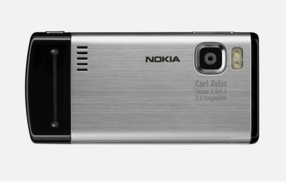 Nokia flip phone with a brushed silver metal back cover and black plastic sides, featuring a Carl Zeiss Tessar 2.8/4.