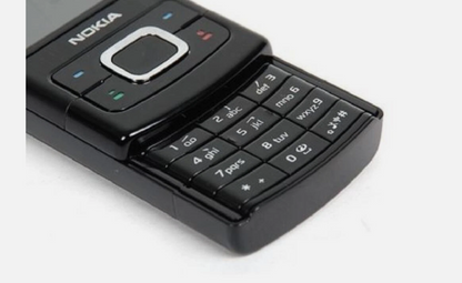 A classic black Nokia mobile phone with its slide-out keypad open, shown on a plain white background.