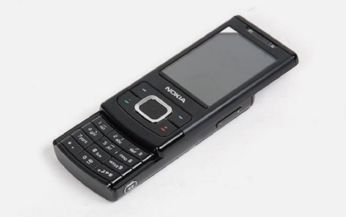 A black Nokia mobile phone with a slide-out QWERTY keyboard and a small screen, photographed on a plain white background.